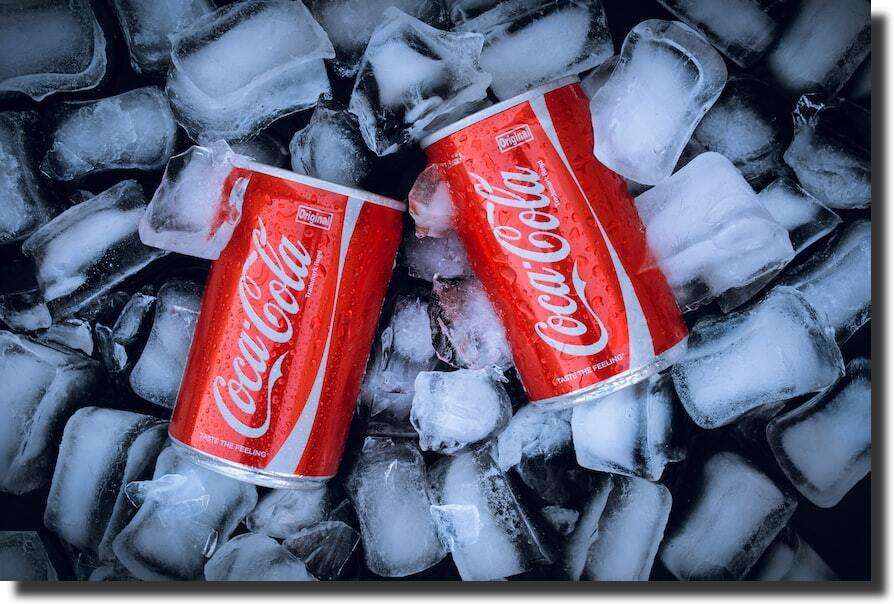 product-photo-of-two-cans-of-coca-cola-on-ice-cubes-brand-experience
